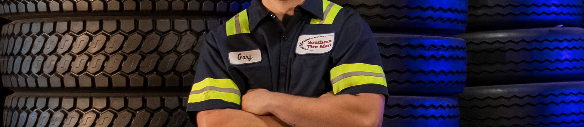 Mechanic standing in front of tires