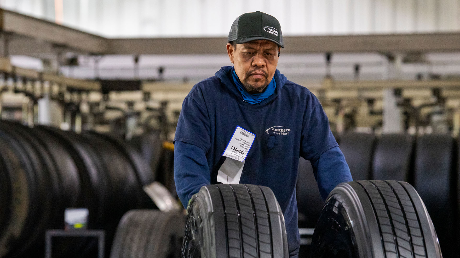 Hard working associate looking at tires